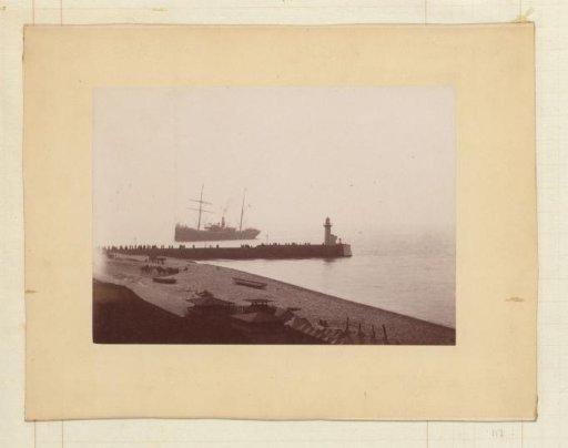Ship arriving at a harbor pier with onlookers