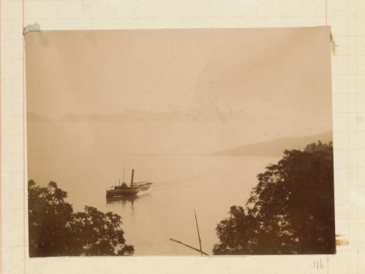 Steamship on a body of water in a mountainous area