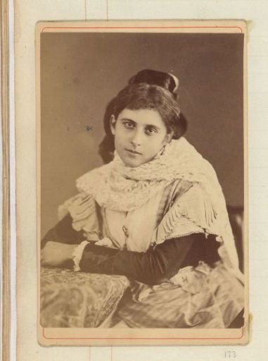 Portrait of a young woman in a blouse with a scarf