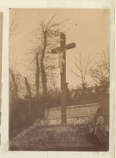 Woman in a Long Mantle at the Foot of a Crucifix