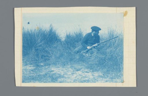 Hunter in the dunes, seated