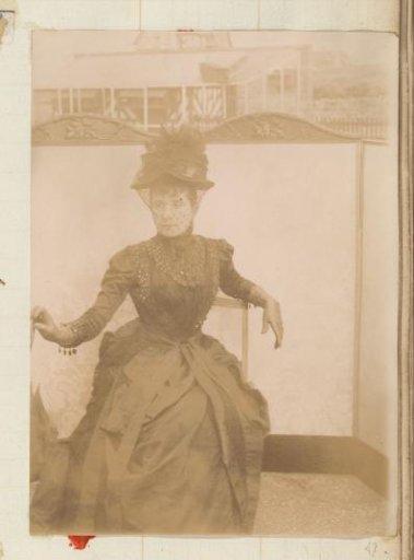 Portrait of a seated woman with hat and veil
