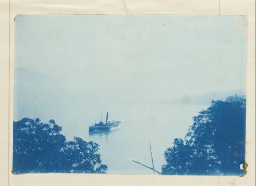 Steamship on a lake in a mountain landscape