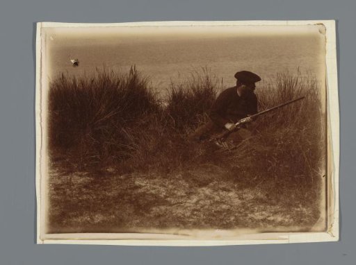 Hunter in the dunes, seated