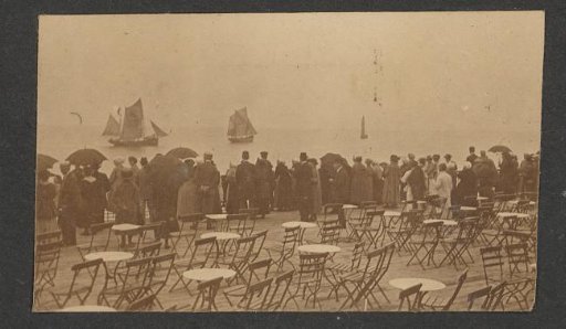 Large group of people watching departing sailing ships