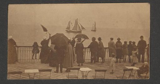 Group of people watching departing sailing ships