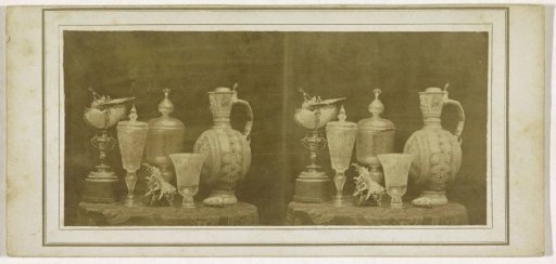 Five vases and a shell on a table