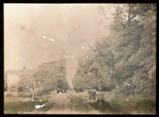 Landscape with a country road and canal, bridges, and a country house