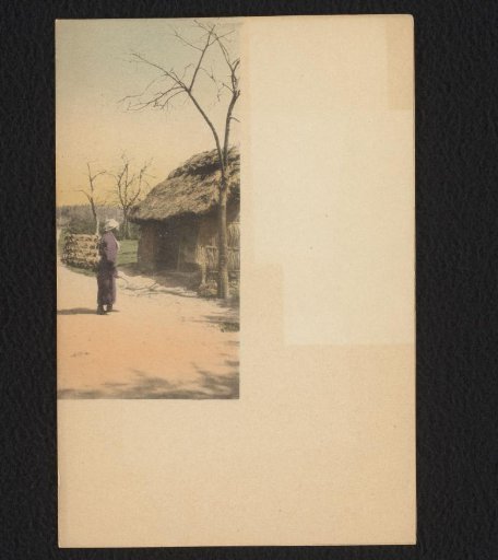 Man Carrying a Load on a Road in a Japanese Village