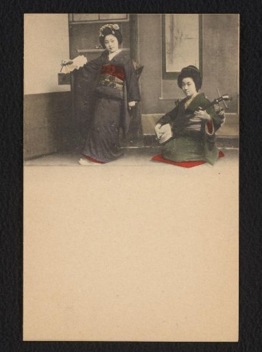 Two young women in an interior, one playing a shamisen