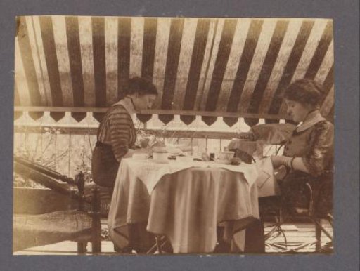 Two Women with Embroidery at a Table on a Terrace