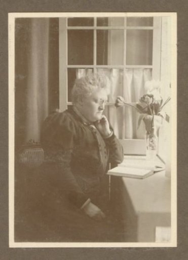 Portrait of G. Vermeulen-Luitjes with Pince-nez, Reading a Book at a Table