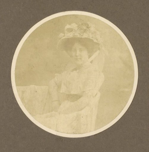Portrait of a seated woman with a hat