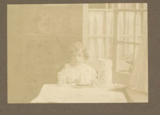 Portrait of a Girl Eating a Meal at a Table