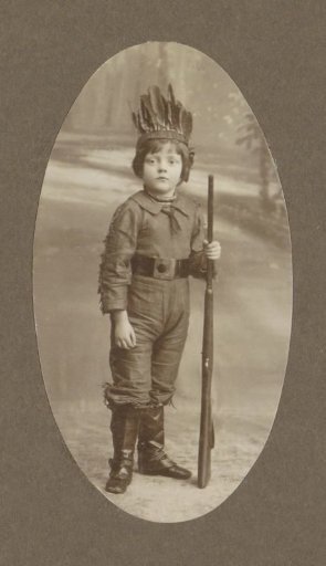 Portrait of a Child with a Feathered Headdress and a Rifle