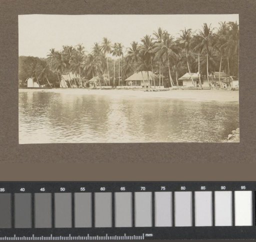 Seaside View with Houses and Palm Trees in the Dutch East Indies