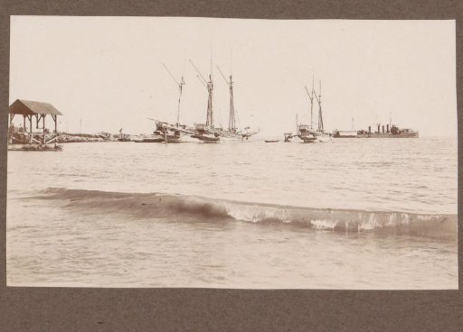 Sailing Ships and (Presumably) a Warship Off the Coast of the Dutch East Indies