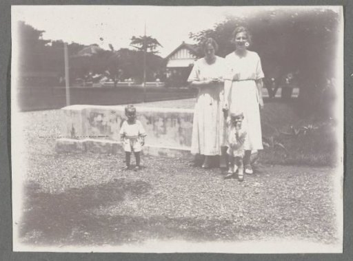Tine Kleiterp-Vermeulen, her son Klaas (both on the left), and two unknown persons on a gravel path in Makassar