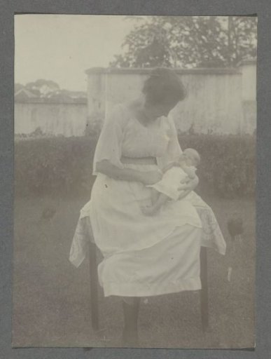 Three-week-old baby Klaas Kleiterp on the lap of his mother Tine Kleiterp-Vermeulen in Malang