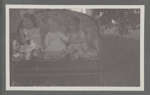 Klaas and Tiny Kleiterp and baby Pieteke on a bench in Tjimahi