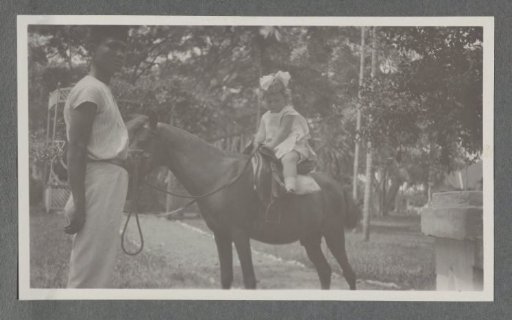 Tiny Kleiterp on a horse held by a Javanese man in Batoedjadjar