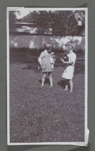 Klaas and Tiny Kleiterp playing in a garden in Adiwerna, Java