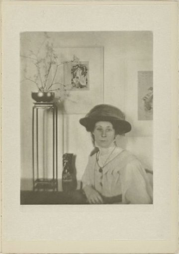 Portrait of an unknown woman with Japanese prints in the background