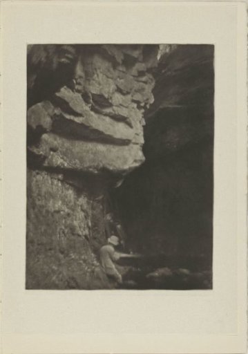 Man sketching in a rocky landscape