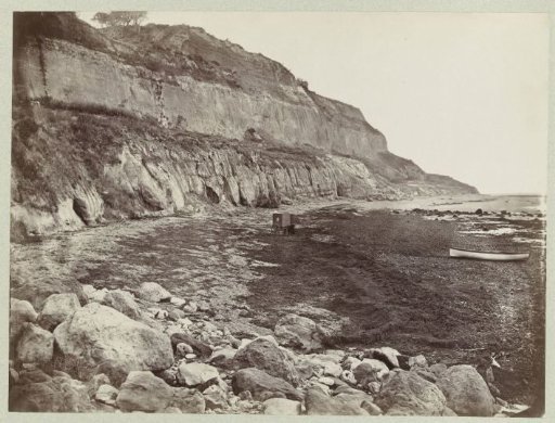 Rocky coastal landscape with boat and cart