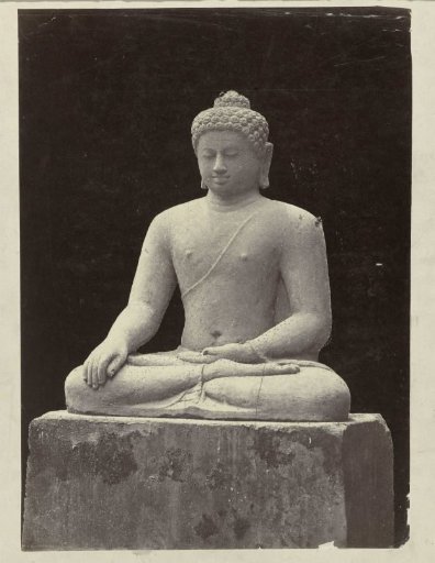 Statue of Buddha in bhumisparsamudra from a niche in the east wall of Borobudur.