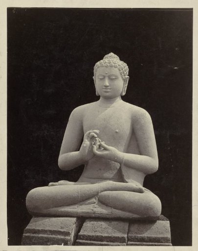 Statue of Buddha in dharmacakramudra from one of the stupas of Borobudur.