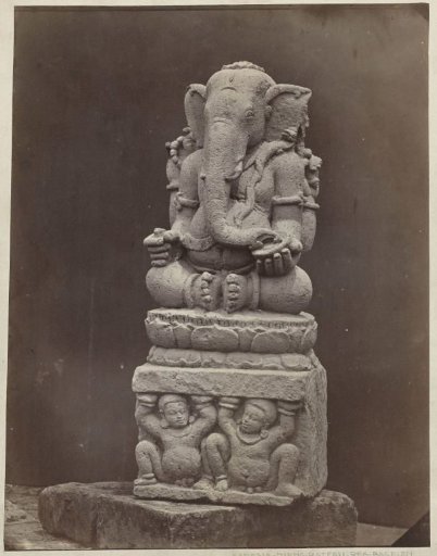 Four-armed Ganesha with a pedestal, decorated with two supporting gana figures. Dieng Plateau, Wonosobo district, Central Java province, 10th century