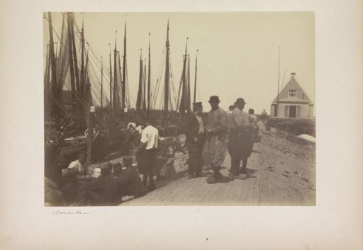 Inhabitants in traditional dress in the harbour of the island of Marken