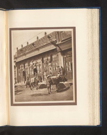 Unknown persons and two donkeys in front of a shop in Peking