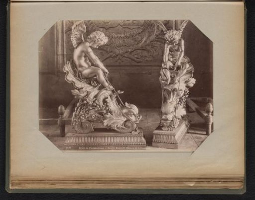 Two gilded statues of angels on dragons