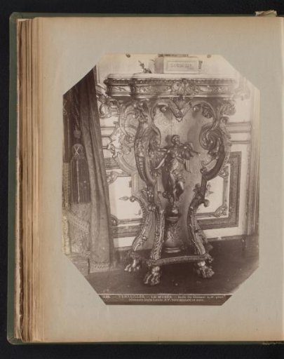 Gilded console with an angel playing a trumpet under the top