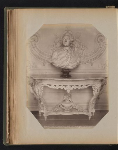 Marble bust of Louis XVI standing on a marble table with ornaments