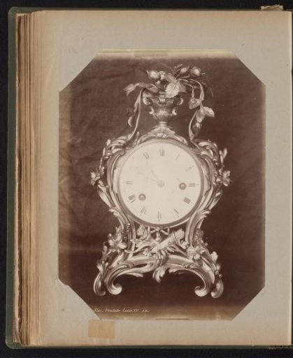 Clock in a gilded case adorned with ornaments