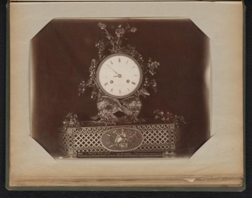 Gilded bronze clock depicting two eagles holding up the clock
