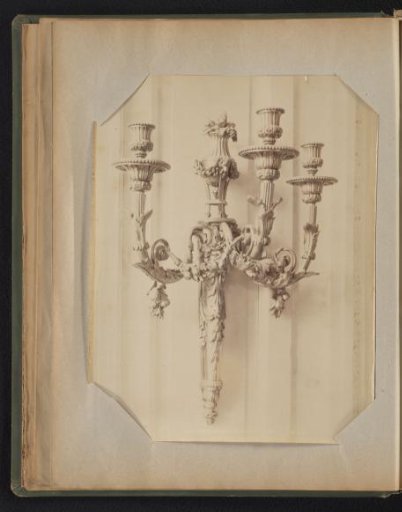 Bronze three-armed wall candelabrum adorned with ornaments and decorations