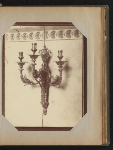 Bronze three-armed wall candelabrum adorned with ornaments