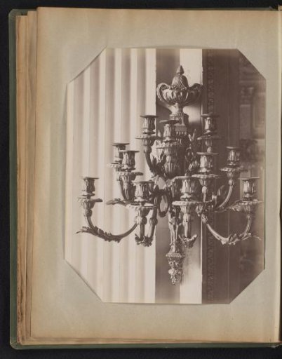 Bronze ten-armed wall candelabrum adorned with ornaments, topped with a bowl