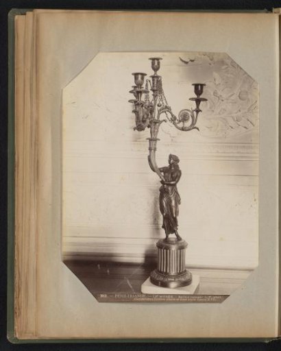 Four-armed candelabrum held by a woman on a pillar in bronze