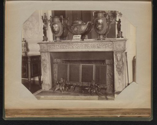 Decorated mantelpiece of blue marble with a three-part cabinet set and two five-armed candelabras
