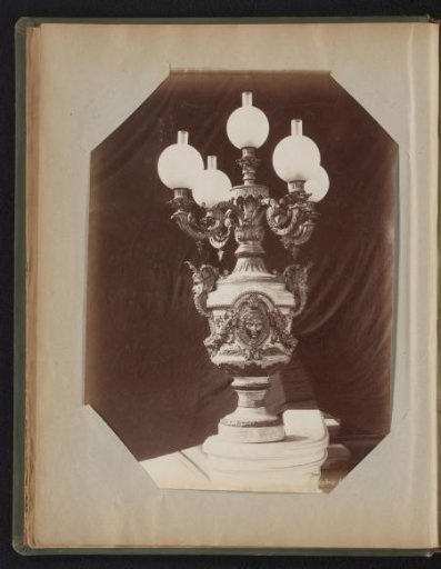 Bronze candelabrum with eight arms and glass globes standing on a foot