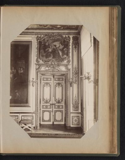 Gilded doors with a painting above, framed by a border with ornaments