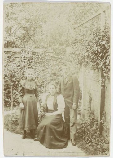 Woman, a girl and a boy posing in a garden