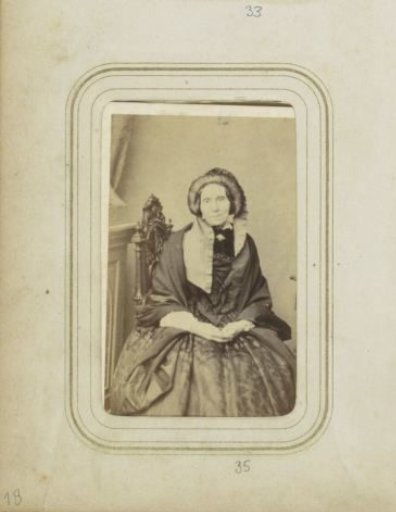 Portrait of a seated woman with a cap