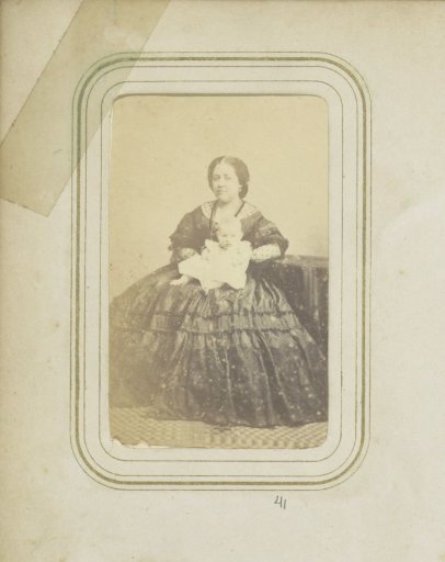 Portrait of a woman in a dress with a baby on her lap