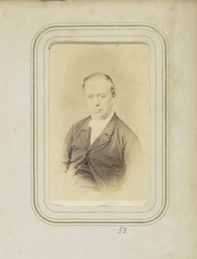 Portrait of a balding man in a coat with a bow